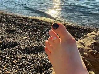 Mistress Lara indulges in foot worship and foot fetish on the beach